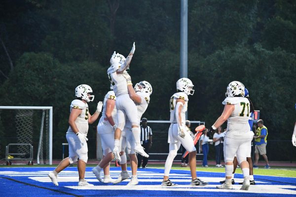 Senior RB Connor Lanham (#2) scores a touchdown for the Flyers @ Ladue on Sept. 13. Lanham rushes for his third touchdown of the season to tie the game 7-7. The senior celebrates with sophmore Jameson Honey (#50). “Great answer to Ladues first score, great start and got hype with the boys,” Lanham said. 