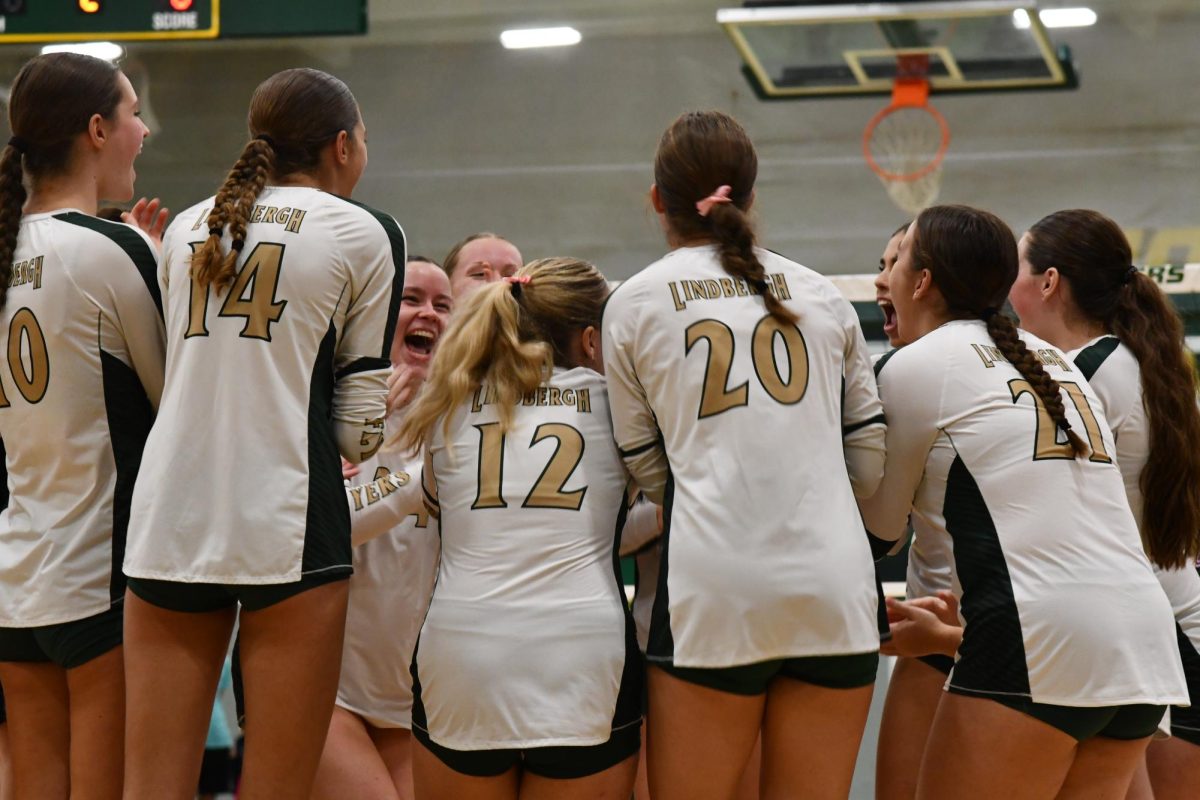 The team celebrates in between sets during their Senior Night game against Rockwood Summit. They won the game in 4 sets to finish off their regular season. “I just really loved all these girls and I think that because we all played really well together it worked,” freshman Gillian Pfeiffer said